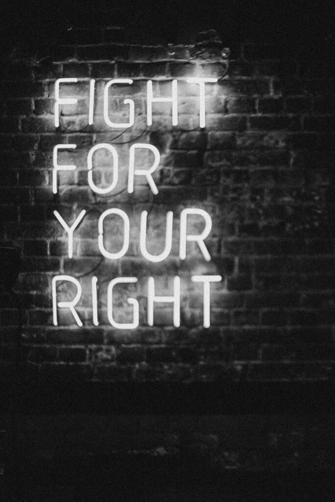 pexels-photo-4753879-4753879 Monochrome neon sign on brick wall with slogan 'Fight for Your Right.' Perfect for motivation and urban themes.